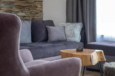 a living room with a couch and a coffee table at Pano Kopaonik Panorama in Kopaonik