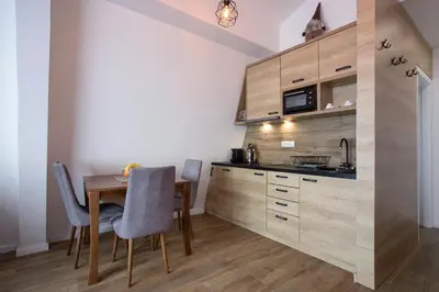 a kitchen with a table and chairs in a room at Pano Kopaonik Panorama in Kopaonik