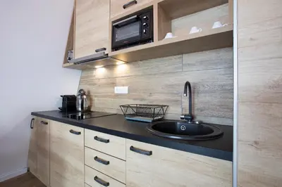 a kitchen with a sink and a microwave at Pano Kopaonik Panorama in Kopaonik