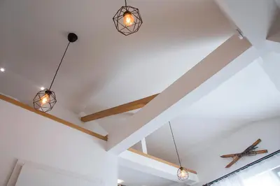 a room with three lights hanging from the ceiling at Pano Kopaonik Panorama in Kopaonik