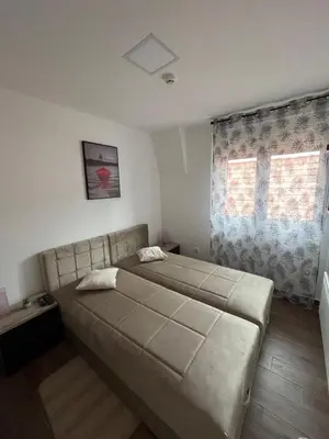 a bedroom with a large bed and a window at Ajrin Apartman Kopaonik in Kopaonik