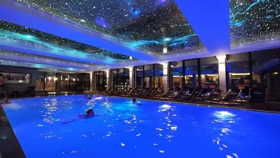 a person swimming in a swimming pool in a building at Apartman Lorena N70a in Kopaonik