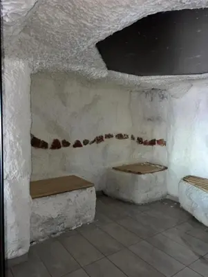 a room with two benches in a white wall at Apartman Lorena N70a in Kopaonik