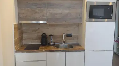 a small kitchen with a sink and a microwave at Apartman Lorena N70a in Kopaonik