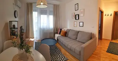 a living room with a couch and a table at Apartman Kardaš in Vrnjačka Banja