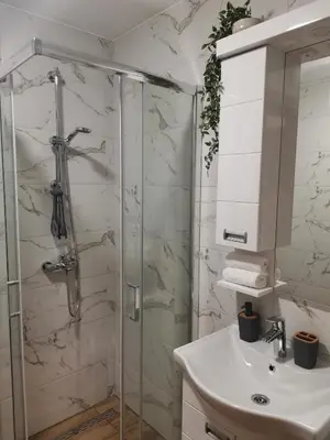 a bathroom with a shower and a sink at Apartman Kardaš in Vrnjačka Banja