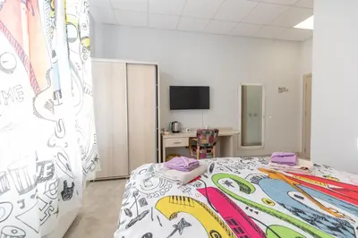a bedroom with a bed with a colorful bedspread at SMART in Niš