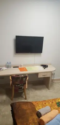 a desk with a flat screen tv on a wall at SMART in Niš
