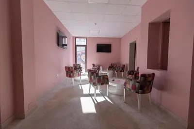 a room with a table and chairs in it at SMART in Niš