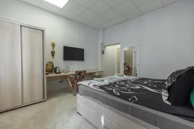 a bedroom with a bed and a desk and a television at SMART in Niš