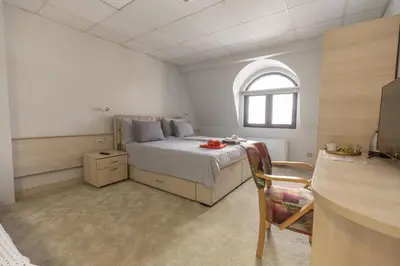a small bedroom with a bed and a window at SMART in Niš