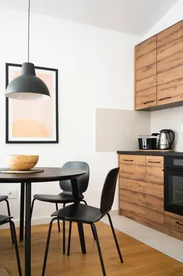 a dining room with a table and chairs in a kitchen at Vidik Residence in Kopaonik