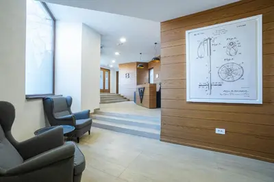 a waiting room with chairs and a drawing on the wall at Vidik Residence in Kopaonik