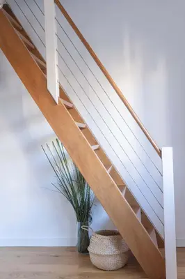 a wooden staircase in a house with a plant at Vidik Residence in Kopaonik