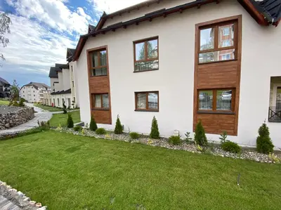 a house with a green lawn in front of it at Kopaonik Milmari Mili P75 in Kopaonik