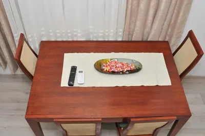 a table with a bowl of sprinkles and a remote control at 
