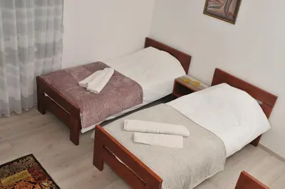 two beds in a room with two towels at 