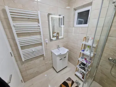 a bathroom with a shower and a sink and a mirror at 