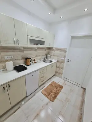 a kitchen with white cabinets and a sink at 