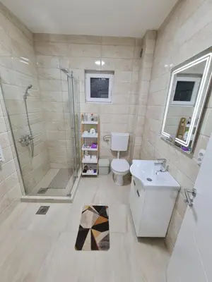 a bathroom with a shower and a toilet and a sink at 