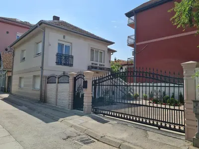 a black fence in front of a house at 
