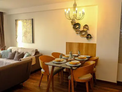 a living room with a table and chairs and a couch at Apt in the Sky - Kopaonik Kraljevi Čardaci in Kopaonik