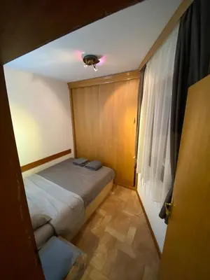 a small bedroom with a bed and a window at Vila Plan 303 Kopaonik in Kopaonik