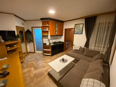 a living room with a couch and a table at Vila Plan 303 Kopaonik in Kopaonik