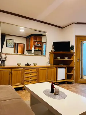 a living room with wooden cabinets and a tv at Vila Plan 303 Kopaonik in Kopaonik