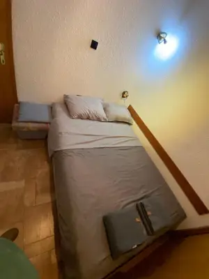 a small bed in a room with at Vila Plan 303 Kopaonik in Kopaonik