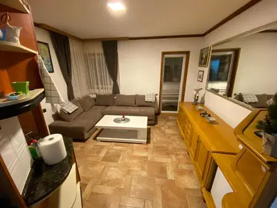 a living room with a couch and a table at Vila Plan 303 Kopaonik in Kopaonik