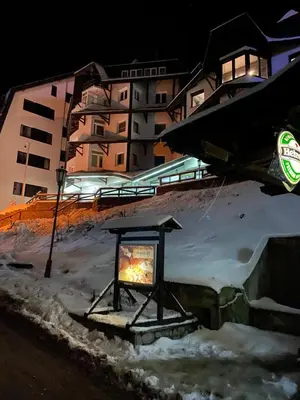 a sign in the snow in front of a building at Vila Plan 303 Kopaonik in Kopaonik