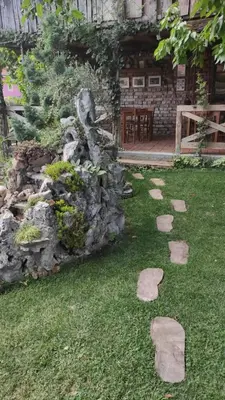 a garden with rocks in front of a house at Apartman 1 Miljković in Soko Banja