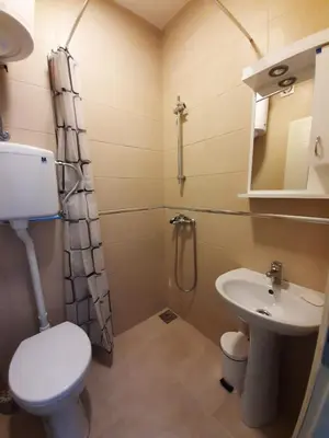 a bathroom with a toilet and a sink and a shower at Apartman 1 Miljković in Soko Banja