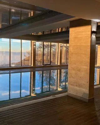 a room with a large window with a view at Milmari N 20 Resort in Kopaonik