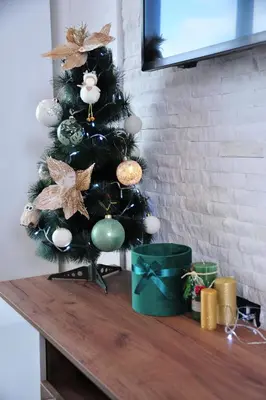 a christmas tree on top of a wooden table at Milmari N 20 Resort in Kopaonik