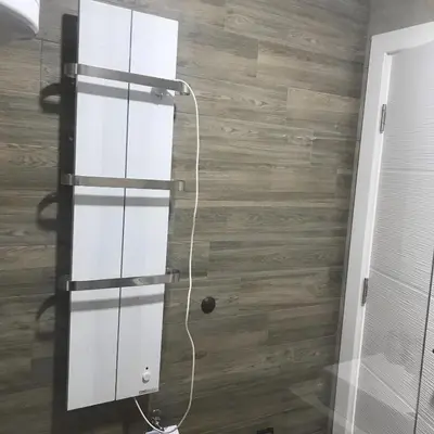 a white cabinet in a room with a wooden floor at Apartman “N 17”Milmari-Kopaonik in Kopaonik