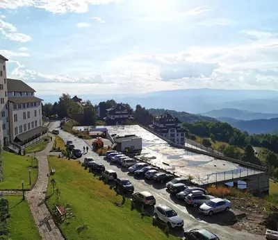 a bunch of cars parked in a parking lot at Apartman “N 17”Milmari-Kopaonik in Kopaonik
