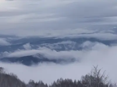 a bunch of clouds in the sky with trees at Apartman “N 17”Milmari-Kopaonik in Kopaonik