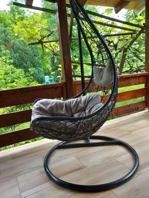 a swing chair sitting on a porch at Studio Sanja Knez in Soko Banja