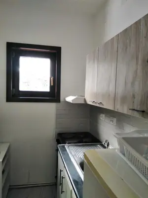 a small kitchen with a stove and a window at Studio Sanja Knez in Soko Banja