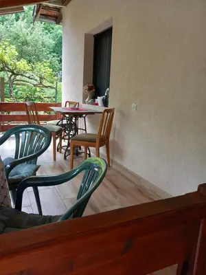 a patio with chairs and a table and tables and chairs at Studio Sanja Knez in Soko Banja