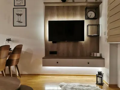 a living room with a flat screen tv on a wall at Apartman Maximus in Vrnjačka Banja