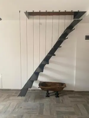 a stair case with a wooden bench in a room at Dvosobni apartmani KopaNiK, Kopaonik (Brzece) in Brzeće