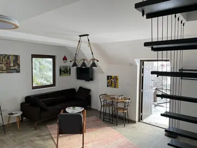 a living room with a couch and a table at Dvosobni apartmani KopaNiK, Kopaonik (Brzece) in Brzeće