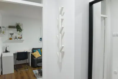 a living room with a sliding door and a desk at Central Apartment in Ćuprija