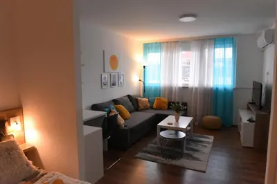 a living room with a couch and a table at Central Apartment in Ćuprija
