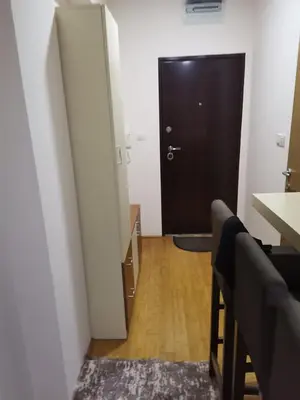 a hallway with a door and a table and chairs at Apartmani Nedeljkovic Brzece Kopaonik in Brzeće