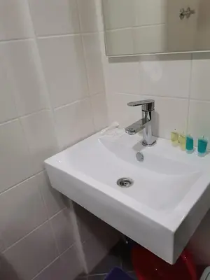 a white sink in a bathroom with a mirror at Apartmani Nedeljkovic Brzece Kopaonik in Brzeće