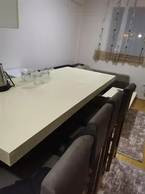 a white table with chairs in a room at Apartmani Nedeljkovic Brzece Kopaonik in Brzeće